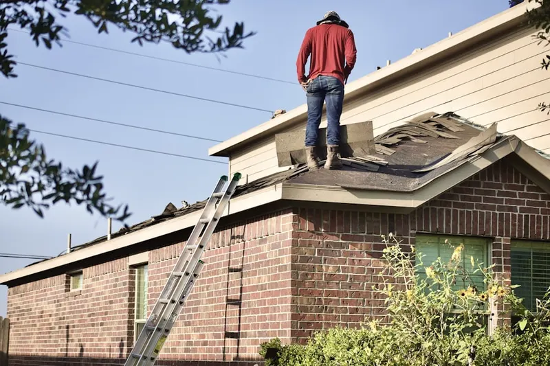 Professional roofer working on a residential roof in Carolines Lake View